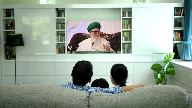 family watching live zikr, Shaykh Nurjan on Tv