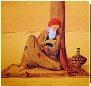 Sufi saint sitting in dessert holding book,sufi,desert